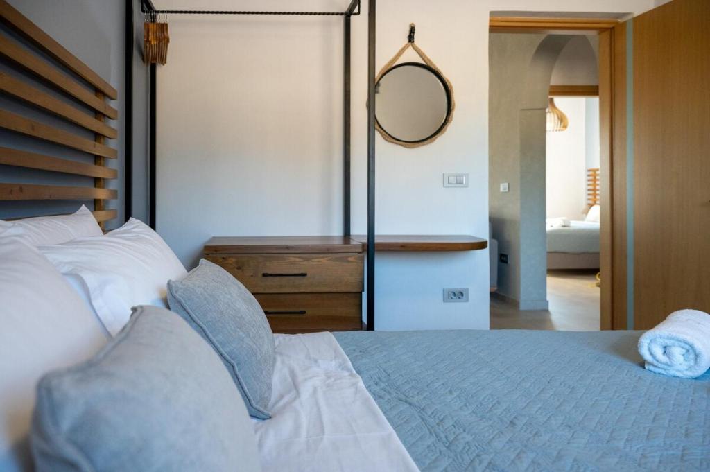 Villa Akalli master bedroom with double bed, sea view balcony, and air conditioning